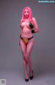 A woman with pink hair in a bikini posing for a picture.