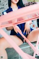 A woman sitting on top of a pink chair.